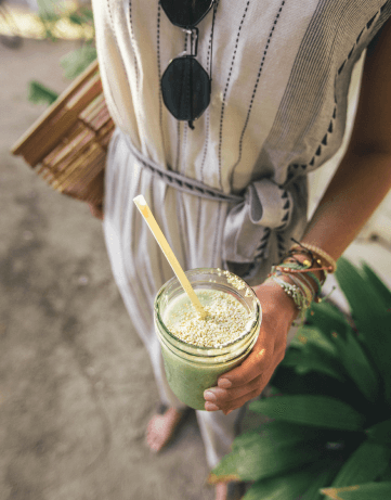 Woman holding a green drink